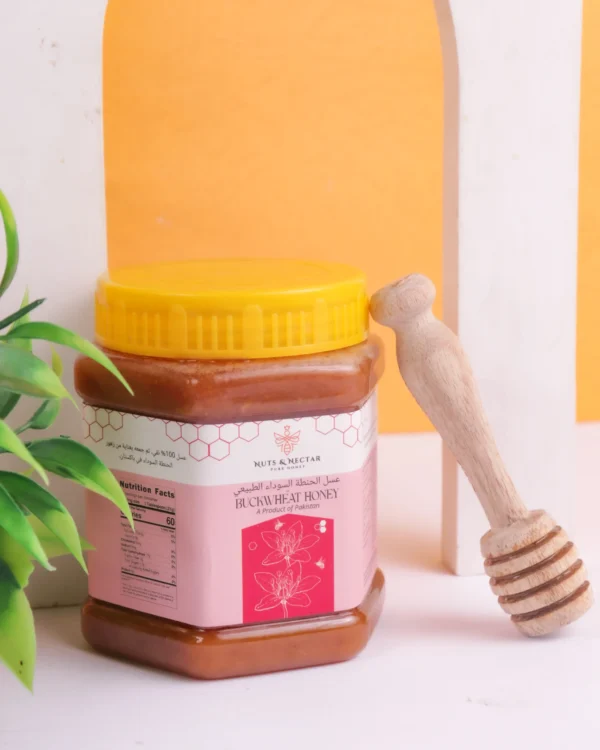 Closed jar of Buckwheat Honey with wooden honey dipper – Nuts & Nectar Pakistan